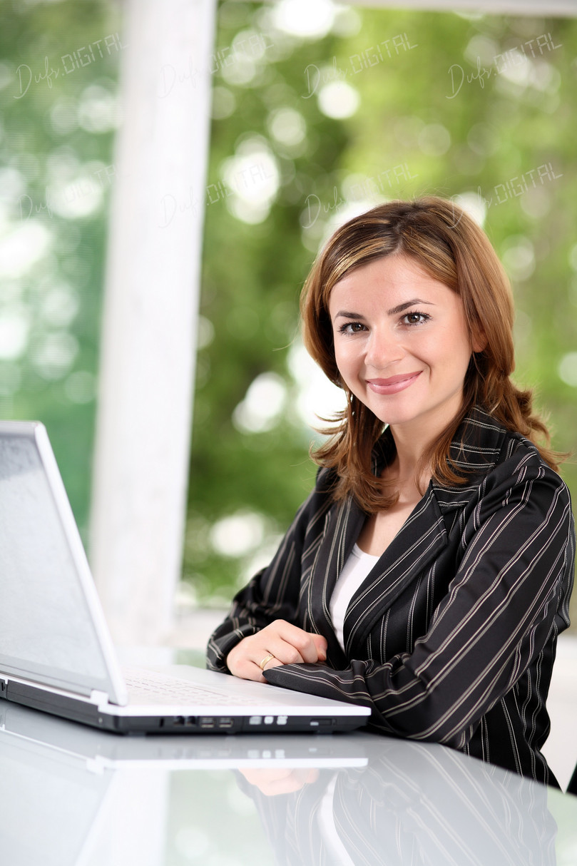 Smiling Businesswoman at Laptop