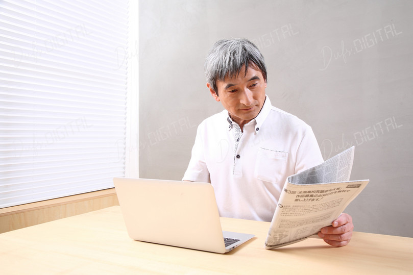Man Reading Newspaper Indoors
