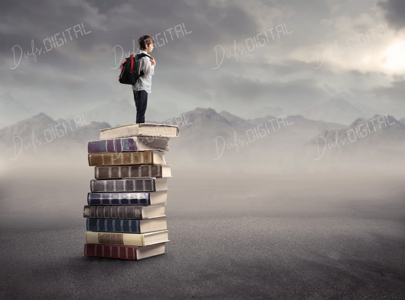 Boy on Stack of Books