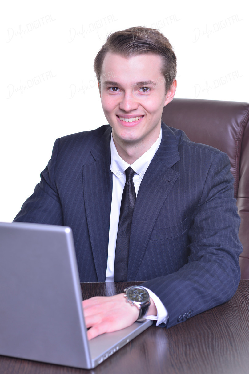 Smiling Businessman at Laptop