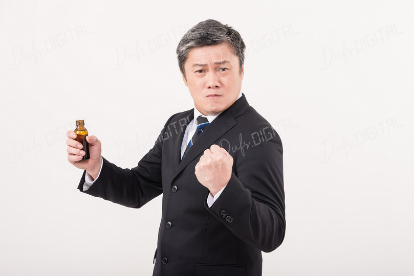 Confident Businessman Holding Bottle