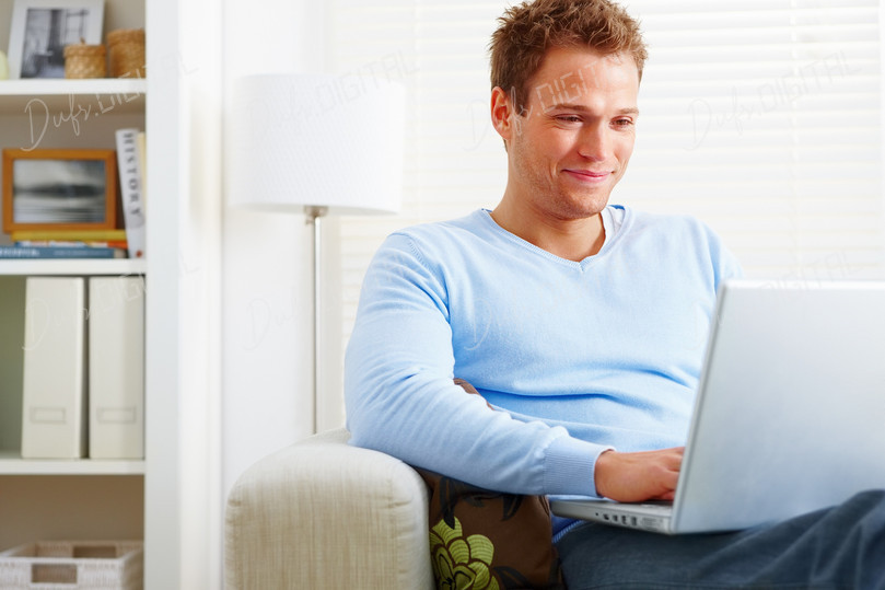Smiling Man with Laptop